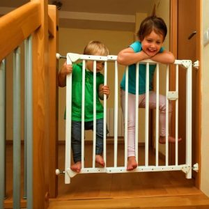 Two baby girls approaching safety gate child safety ss 2